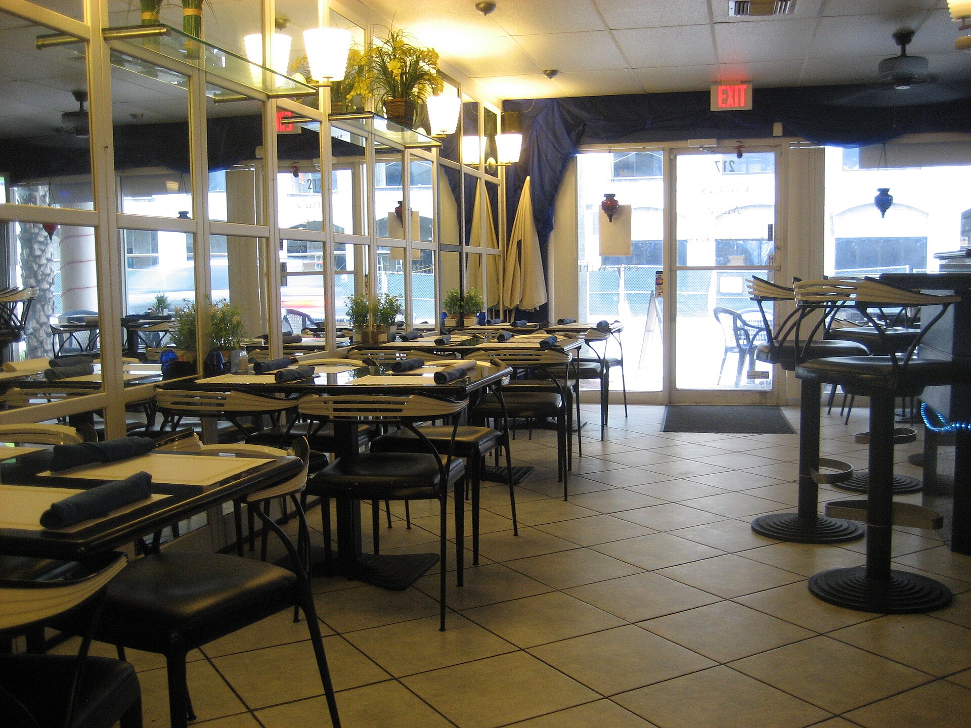 The warm interior of an Indian restaurant dining room.
